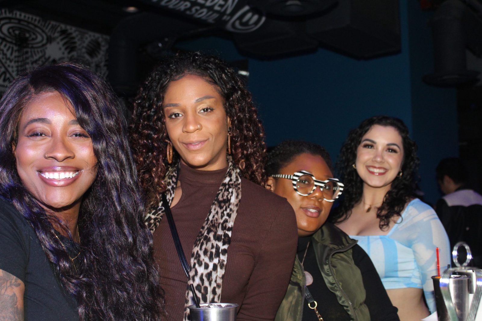 A group of guests smiling at the bar